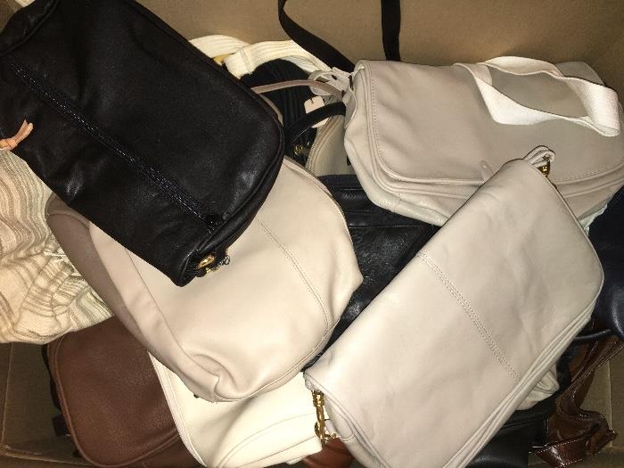 Dozens of handbags, totes, duffel bags, wallets and more--many leather.