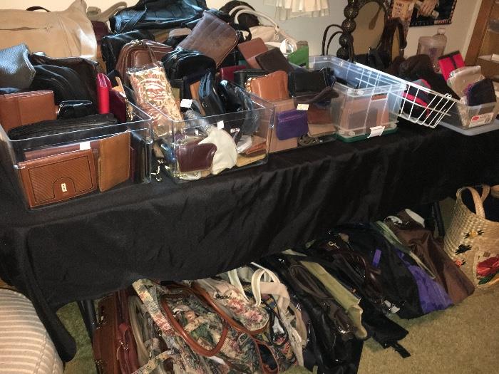 Dozens of handbags, totes, duffel bags, wallets and more--many leather.