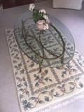 Wool rug, glass and iron cocktail table. 