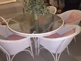 Glass and wicker patio set--round table and four chairs.