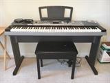 Yamaha Portable Grand DGX-520 electric keyboard with bench.