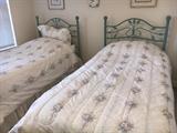 Lovely matching twin beds--decorative metal headboards, complete as shown with bedding.