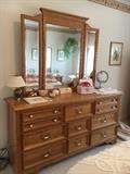 Sold oak bedroom group by Jamestown Sterling. Set includes large dresser with 3-way mirror, chest on chest, two nightstands and queen size bed. Just replace the hardware for a quick update.