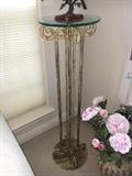 Metal and glass pedestal.