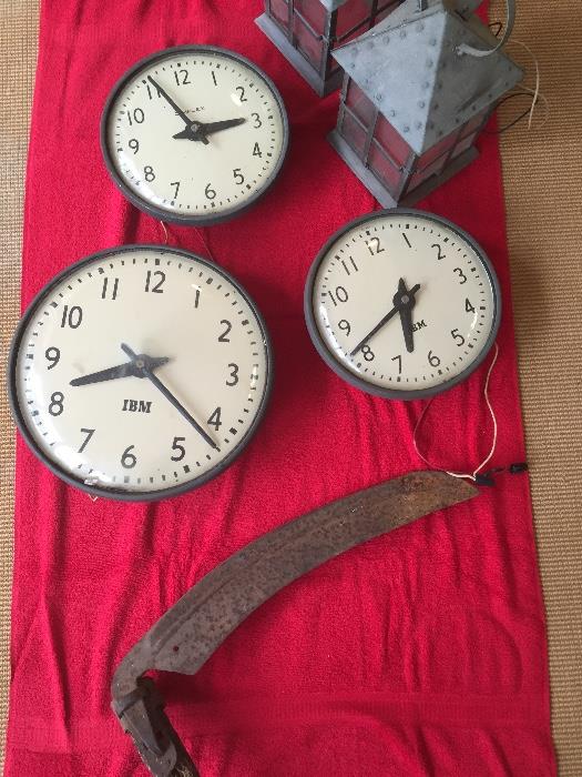 Antique school clocks, lanterns, and tools.