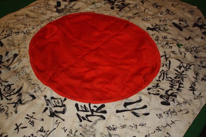 Silk Japanese flag captured during WWII.  I don't know what the writing is.  