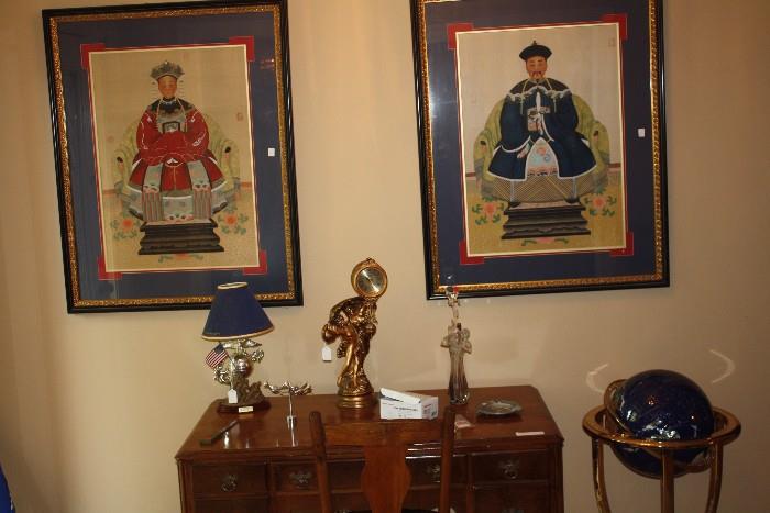 Asian prints in the foyer.  The middle item on the desk is a lamp.  The globe on the right is special.