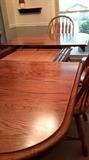 Solid oak table expands to 12 foot with two hidden leaf/leaves extensions