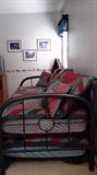 Boys room includes metal frame trundle bed