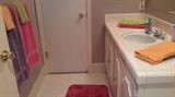 Brightly colored bathroom towels and rugs