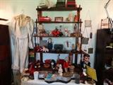 Mahogany Etagere in Collectibles Area. This is mainly Antique Tin, Wind-Up Toys but Lots of other Goodies. That's an antique lace wedding Dress to left