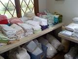 lots of linens, towels, spreads, blankets, sheets, snuggies, etc.