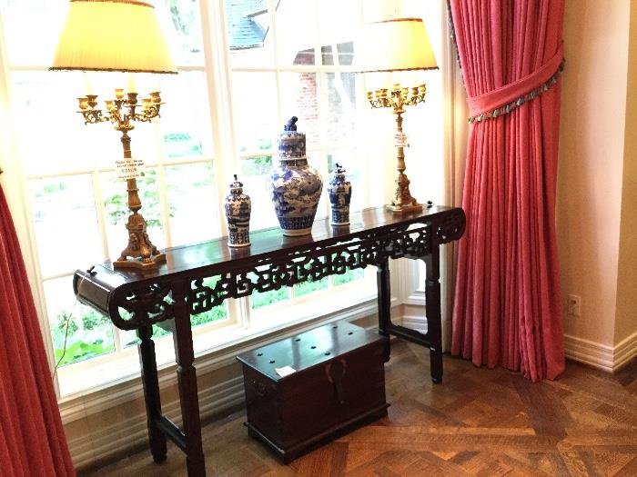 Altar table; antique tool chest trunk; bronze gilt candelabra lamps with custom shades