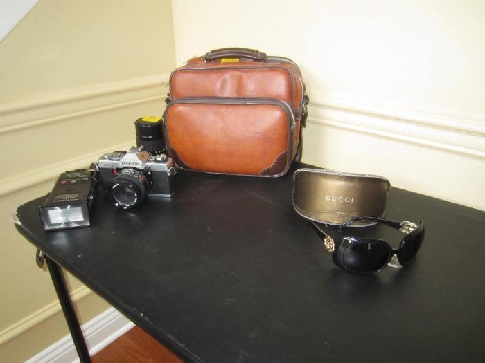 gucci sunglasses, minolta camera and leather case