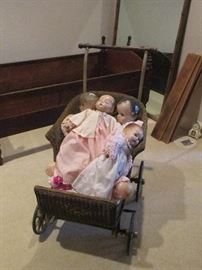 antique wicker baby buggy and dolls