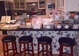 Bar stools, and kitchen stuffed with China sets, pots, pans, small appliances, many sets of flatware, Tupperware, 