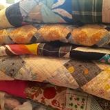 Old quilts and quilt tops including fabrics and some Hawaiian quilting