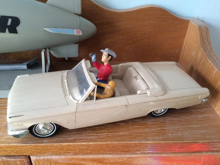 Vintage Thunderbird model car with original toy figures.