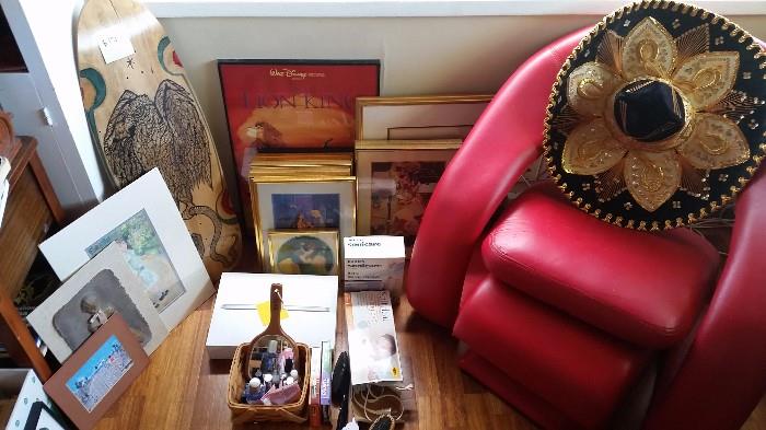 old end table, Disney lithographs, art frames, red chair, sombrero