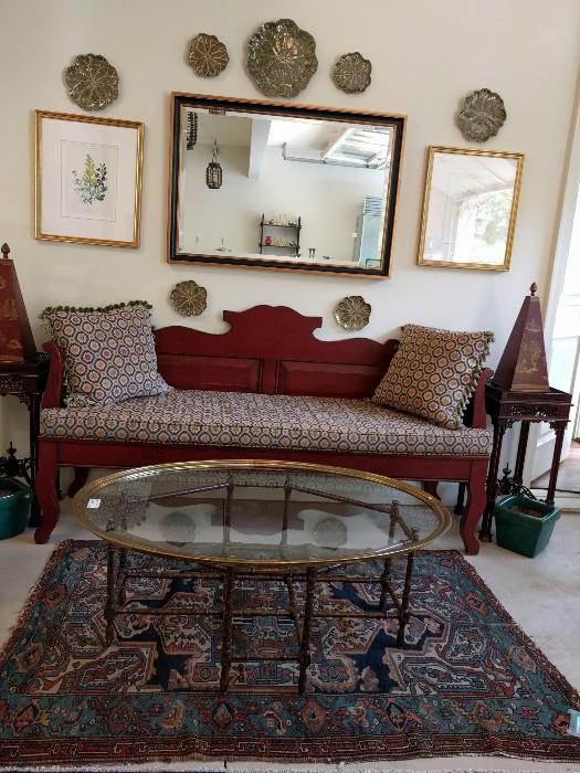 Vintage mahogany bench, w/upholstered seat and pillows, pair of mahogany side tables, faux bamboo/brass& glass coffee table atop a wonderful Persian Heriz. Vintage LaBarge mirror above the bench.