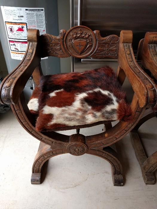 Yippee-Ki-Yay! Those English certainly knew how to sling up a sling chair, with cowhide fabric and an extra pillow, just because. If you squint, you can see your family crest in the hand-carved oak.