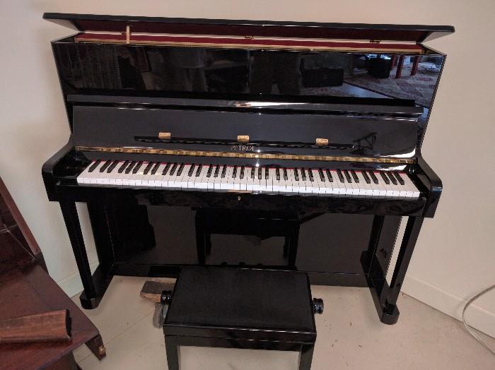 For the ivory tickler in your life, enter the Czechoslovakian black lacquer upright piano, w/matching stool.