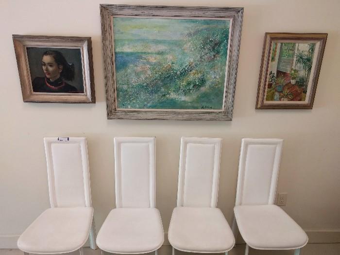 This is not a doctor's office waiting room. FAR from it. Here you see a set of four Italian chairs, enrobed in virgin-white Corinthian leather. Above them, four original oil paintings.