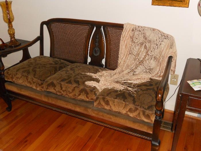 3-Cushioned antique love seat with cane backing