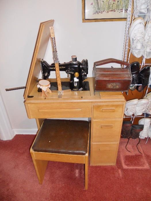 Singer sewing machine in blonde cabinet with stool