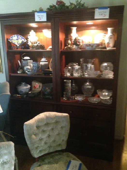 lighted display cabinets with Asian porcelain and crystal