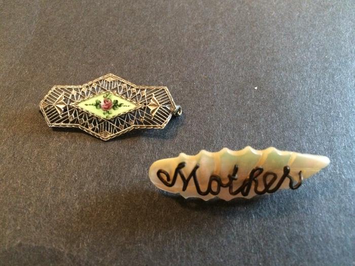 Antique Pins.  One is a sterling Silver filigree pin when an enamel Center.  The second is an antique Victorian or Edwardian pin of carved mother of pearl with 'Mother' spelled out in wire.