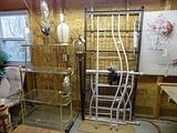 Large gold metal plant stand or shelving unit and twin size day bed with back and side boards as well as springs.