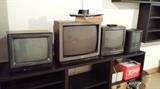 Old TVs and black shelving