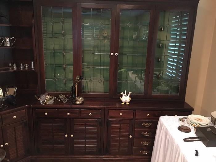 Gun cabinet with leaded glass accents.