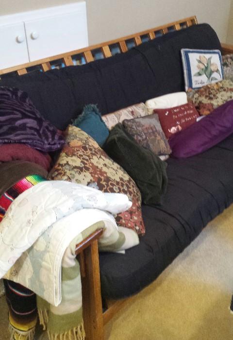 futon, pillows, blankets
