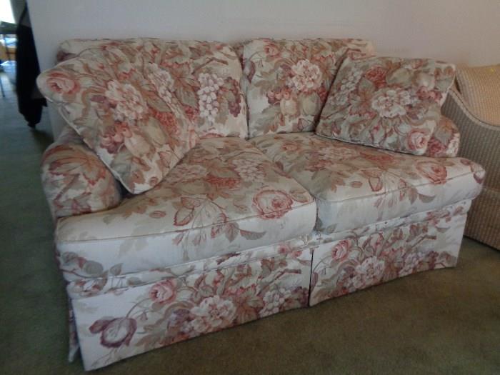Love seat with pillows.