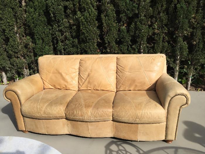 Tan leather sofa; matching club chair and ottoman also available