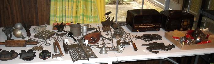 Primitive untensils, cast iron match safes, old radios, etc
