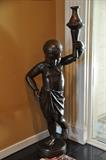 Bronze figurine of child holding a torch