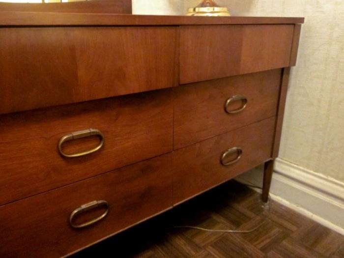 Mid Century Modern triple dresser with 9 drawers, matching mirror, pencil legs, brass hardware, by Stanley Furniture