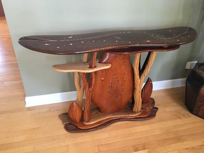 One of a kind hand carved wood table purchased at the Highland Park fine art festival