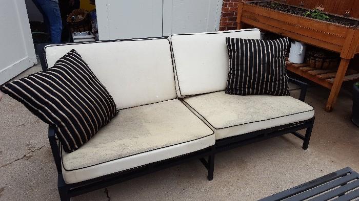 Patio couch with metal frame, cushions and pillows included