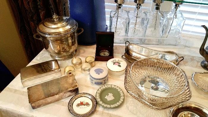 silver plate ice bucket....cigarette boxes....glass liquor decanters...wedgwood...silver plate baskets...
