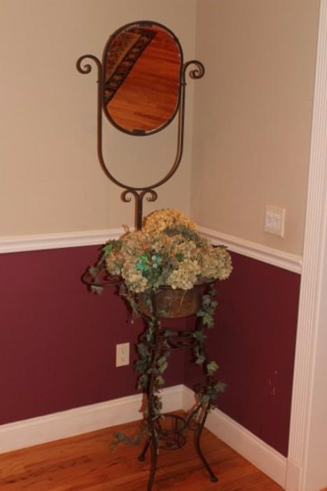 Mirror, floral arrangement and stand