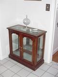 Small lighted curio with glass shelves