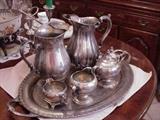 Two silverplated water pitchers, cream and sugar sets, and silverplate tray