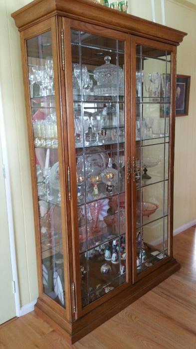 display case with Waterford Crystal, Depression Glass pieces, Goebel Di Grazia collectibles