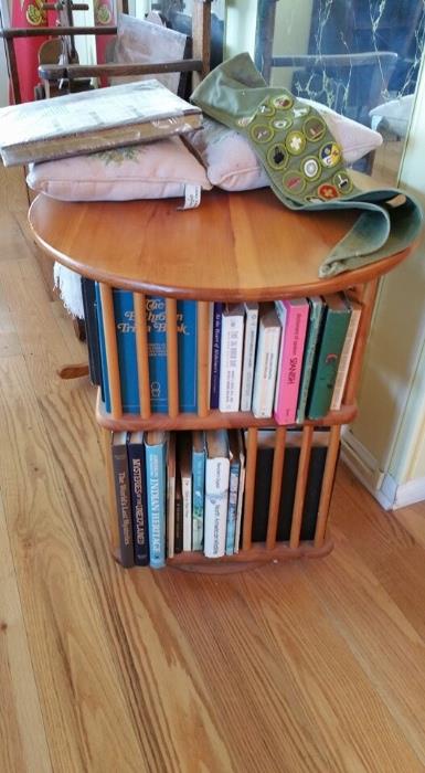 Revolving bookcase end table with books 