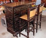 Mediterranean carved wood bar with two stools