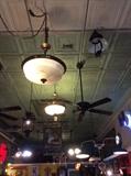Huge assortment of vintage and antique light fixtures and fans. 